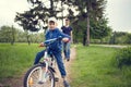 Small boy riding a bike together with his father Royalty Free Stock Photo