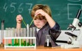 Small boy at science camp. microscope at lab. Scientific experiment. Pupil looking through microscope. student do Royalty Free Stock Photo