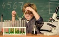 small boy at science camp. microscope at lab. Scientific experiment. Pupil looking through microscope. student do Royalty Free Stock Photo