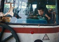 Small boy sitting in cab of bus on drivers seat and imagining himself as bus driver Royalty Free Stock Photo