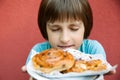 The small boy sniffs butter buns Royalty Free Stock Photo