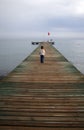 Small boy standing on a pier