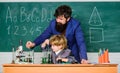 Small boy with teacher man. solution in research laboratory. Genetic research. Wisdom. Back to school. son and father at Royalty Free Stock Photo