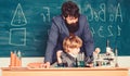 Small boy with teacher man. Wisdom. Back to school. son and father at school. Pharmacy and chemistry theme. solution in Royalty Free Stock Photo