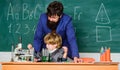 Small boy with teacher man. Wisdom. Back to school. son and father at school. Pharmacy and chemistry theme. solution in Royalty Free Stock Photo