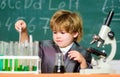 Small boy using microscope at lesson. microscope at lab. Back to school. Pupil looking through microscope . student do Royalty Free Stock Photo