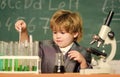 small boy using microscope at lesson. microscope at lab. Back to school. Pupil looking through microscope . student do Royalty Free Stock Photo