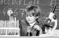 small boy using microscope at lesson. microscope at lab. Back to school. Pupil looking through microscope . student do Royalty Free Stock Photo