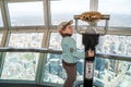 Small boy using telescope on CN tower