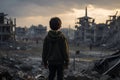 Small boy in war torn area, facing a desolate, destroyed building Royalty Free Stock Photo