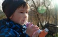 A small boy who suffering from illness bronchial asthma getting treatment with aerosol inhaler outdoors