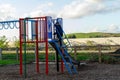 A small boy in winter clothes climbing a child climbing frame in the park Royalty Free Stock Photo