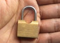 Small brass metal lock on palm of hand