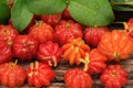 Small Brazilian fruit called pitanga - Suriname cherry in rustic wood background