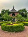 Small brick building with doorway arches at garden