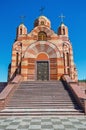 Small brick church with three gilded domes