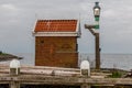 Small brick fishing house by the sea with a lantern in front Royalty Free Stock Photo