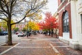 Small brick square crowded of people in Portsmouth downtown on a cloudy autumn day
