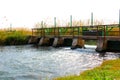 Small bridge with open floodgates on a river