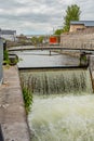 Small bridge over the Eglinton Canal Lock with running water forming small waterfalls Royalty Free Stock Photo