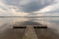 A small bridge over the lake. Reflection of clouds on the lake's surface Royalty Free Stock Photo