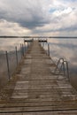 A small bridge over the lake. Reflection of clouds on the lake's surface Royalty Free Stock Photo