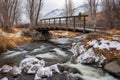 a small bridge spans over a rushing hot spring creek Royalty Free Stock Photo