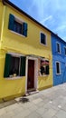 Small bright colorful old houses on the island of Burano, Italy. Local flavor and traditions on the Venetian