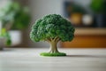 Small broccoli tree is sitting on a table Royalty Free Stock Photo