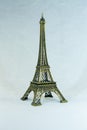 Small bronze copy of Eiffel tower figurine isolated on white background. Royalty Free Stock Photo