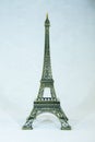 Small bronze copy of Eiffel tower figurine isolated on white background. Royalty Free Stock Photo