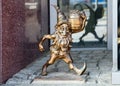 The small bronze statue gnome by name - Leprokonus, gnome with a barrel of gold