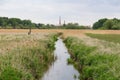 Small brook with meadow and old factory