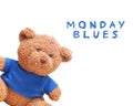 Small bear wear a blue shirt isolated with white background. Typo word `Moday Blues`