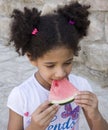 Small brown girl African American appearance eating watermelon Royalty Free Stock Photo