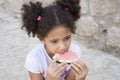 Small brown girl African American appearance eating watermelon Royalty Free Stock Photo