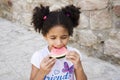 Small brown girl African American appearance eating watermelon Royalty Free Stock Photo