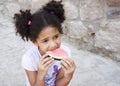 Small brown girl African American appearance eating watermelon Royalty Free Stock Photo