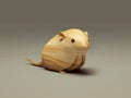 Small brown mouse sitting on top of wooden block. The mouse appears to be looking at something in front of it, possibly