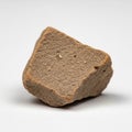 A small, brown rock with an irregular, roughly cuboidal shape. Royalty Free Stock Photo