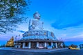 Small Buddha image in front of white big Buddha