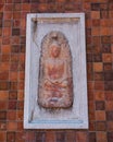 Small buddha image at wall