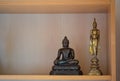 Small buddha statue on buddha shelf at Thailand home Royalty Free Stock Photo