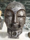 A small Buddha statue with raindrops. Una pequeÃÂ±a estatua de Buda con gotas de lluvia