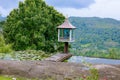 A small Buddha statue set in the middle of a beautiful hilly landscape in sri lanka