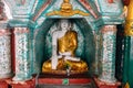 Small Buddha statue at Shwedagon Pagoda in Yangon.