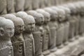 Small buddha statues standing at temple, Japan. Buddhism background.