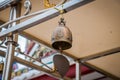 The small Buddhism religious bell. Closeup shot of iron bells hanging in temple. Royalty Free Stock Photo