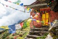 Small Buddhist monastery decorated with multicolored Tibetan prayer flags with mantras on Kothe - Thangnak climbing Mera peak