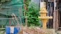 Small Buddhist sanctuary among the heaps of garbage on a city street, a garbage dump near a